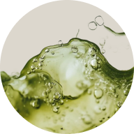 Close-up of green liquid with bubbles on a beige background
